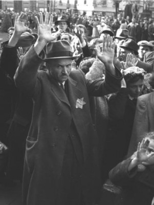 Budapest, Hungary – Hungarian and German soldiers drive arrested Jews into the municipal theatre. October 1944. Wikimedia